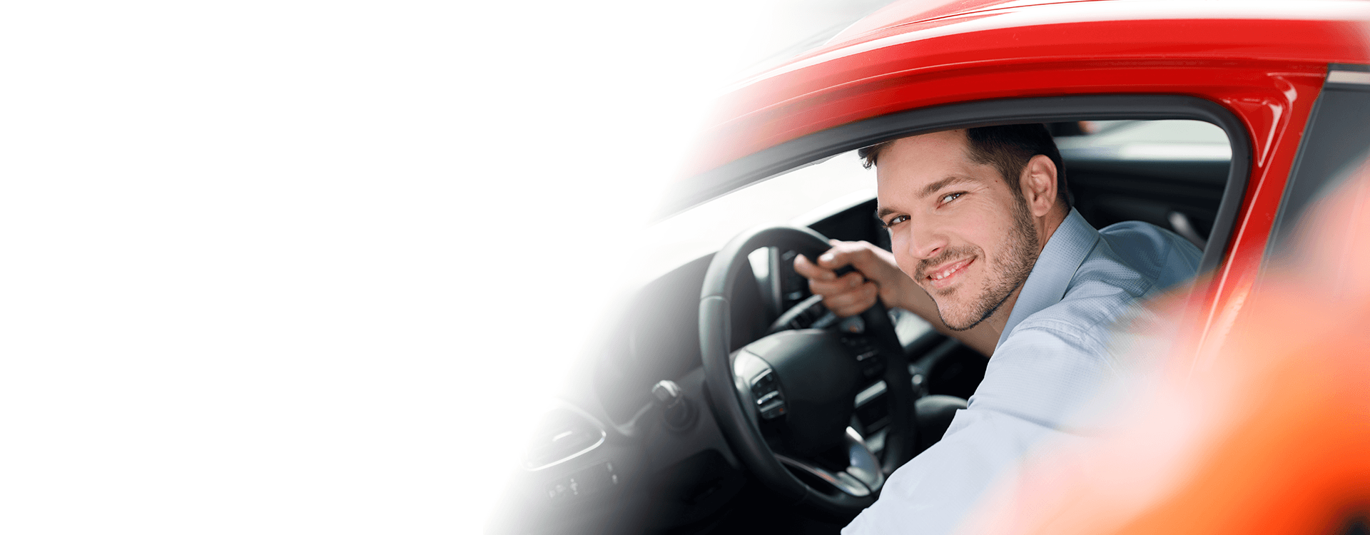 man smiling sitting in the car with doors opened