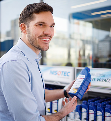 man smiling and holding nisotec product